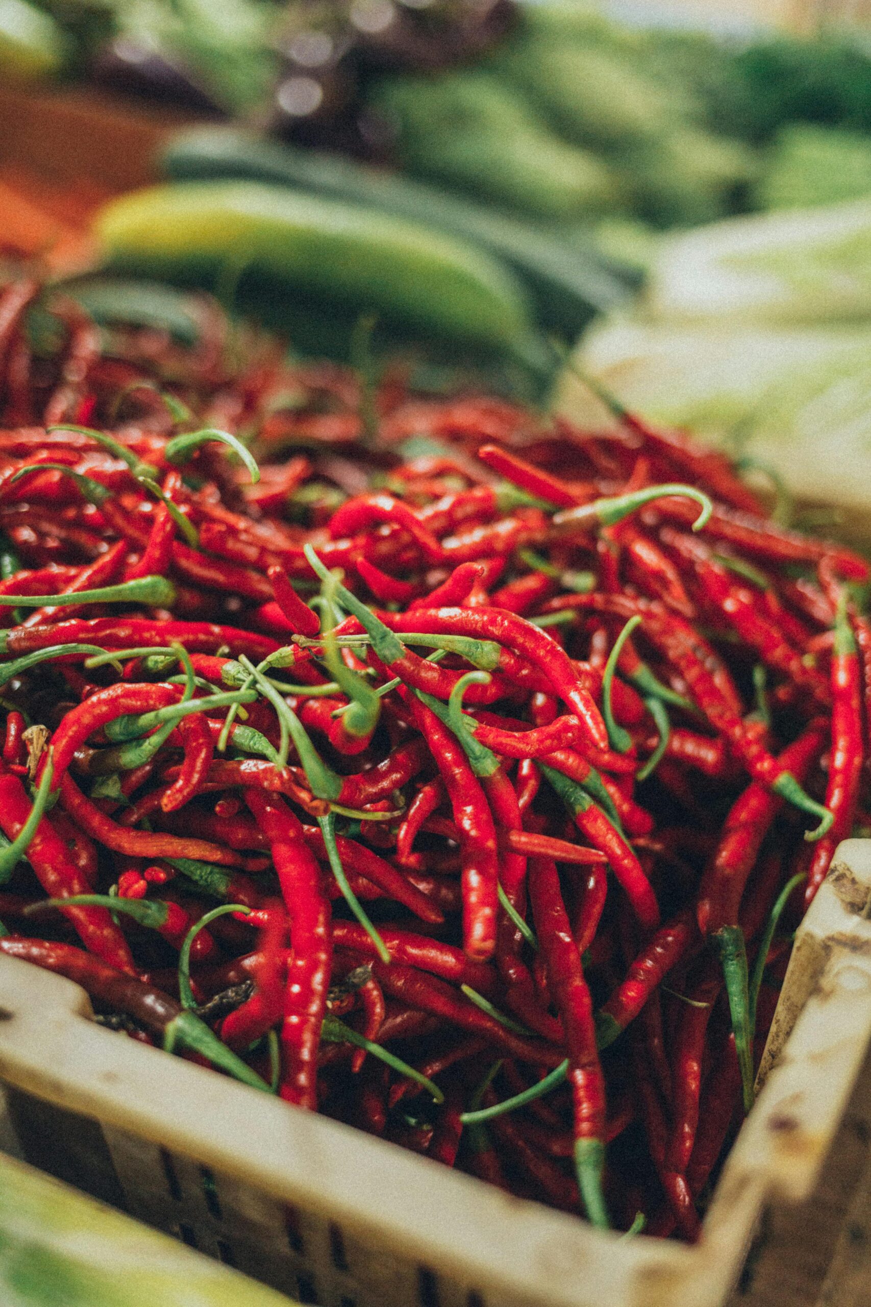 A bucket of fresh red peppers.